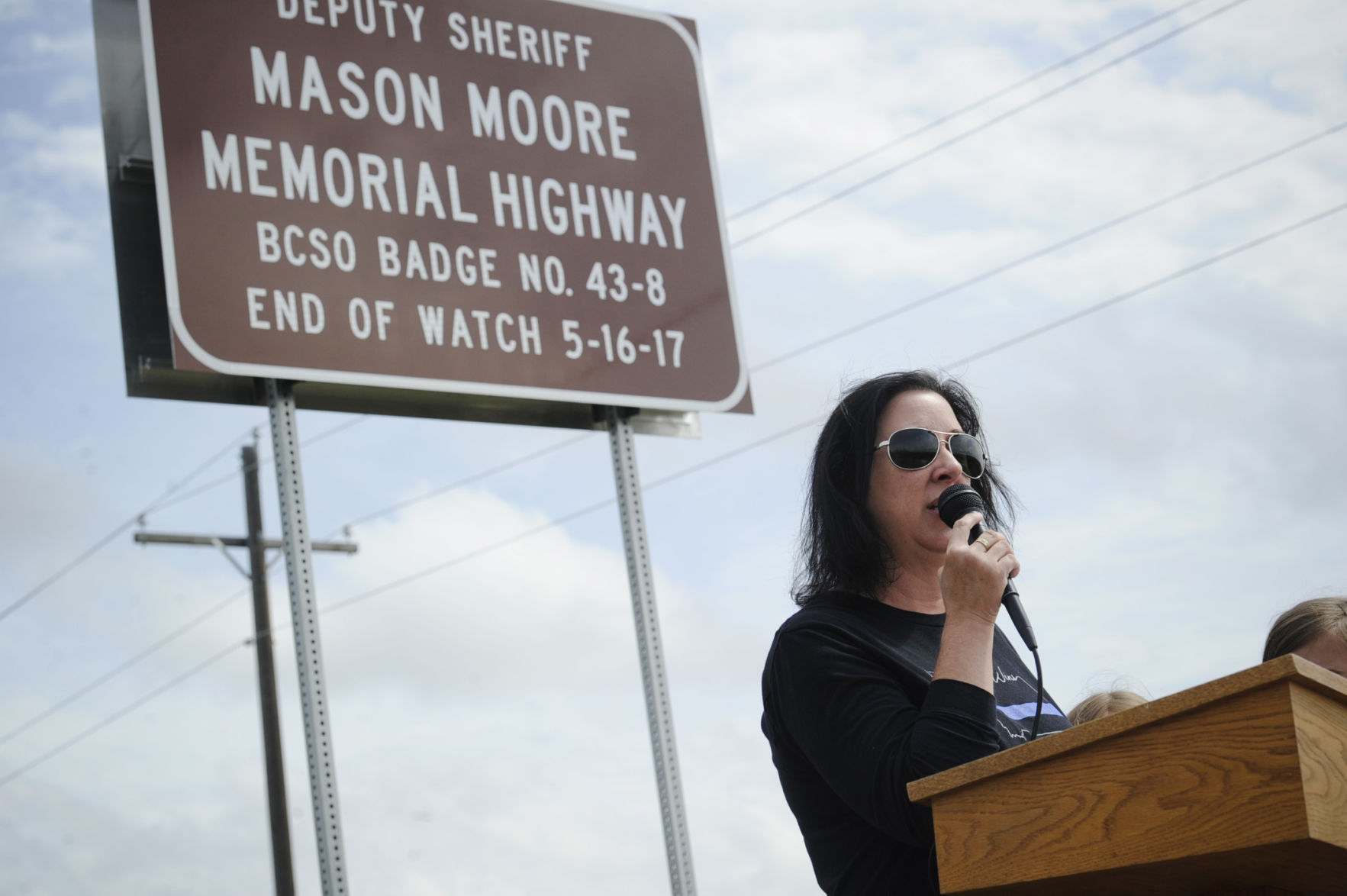 Jodi Moore, wife of Deputy Mason Moore, speaks